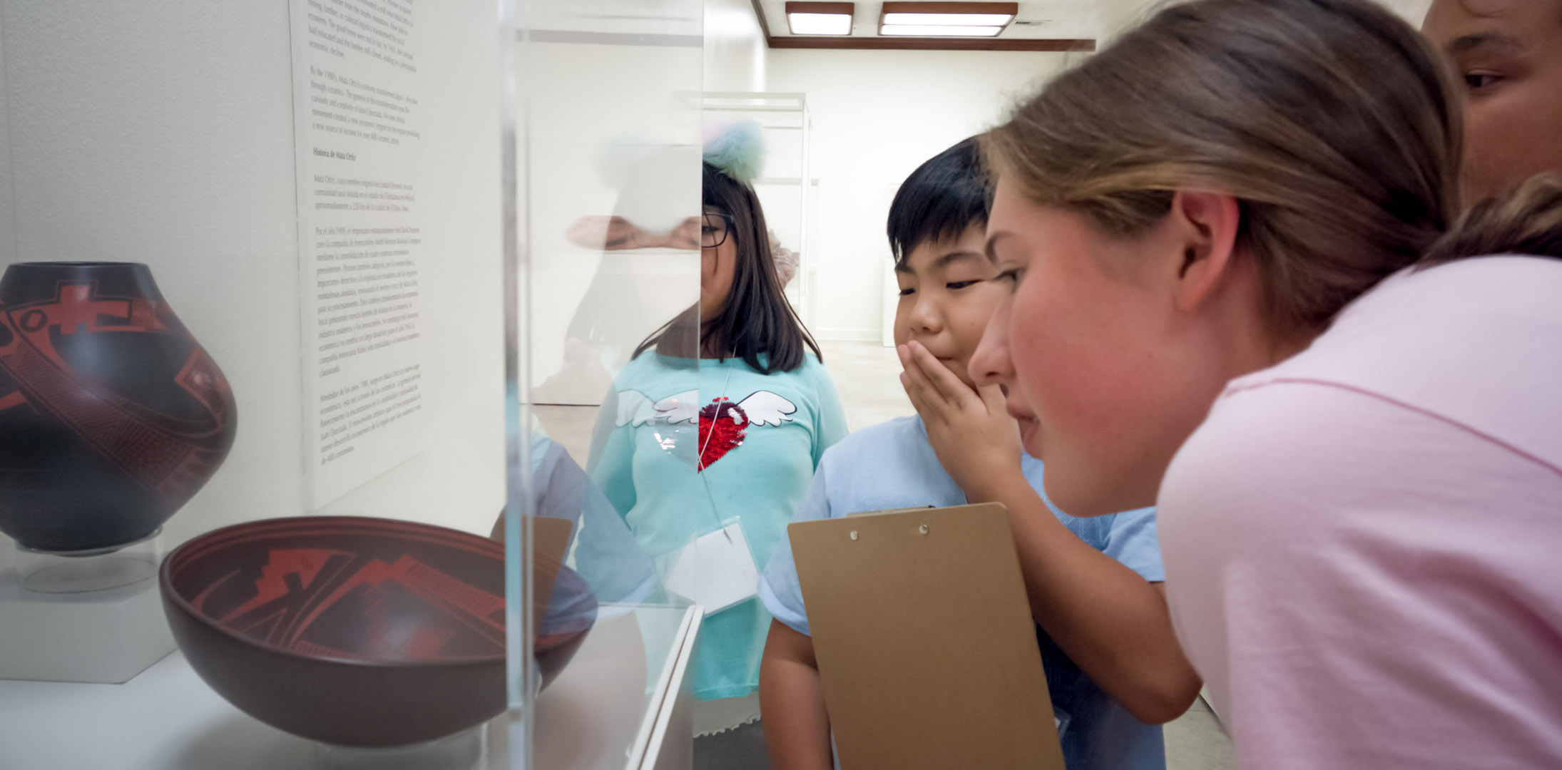 An image of K-12 students touring an Exhibition at AMOCA